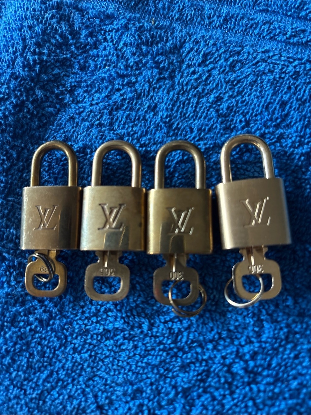 Louis Vuitton Gold Tone Padlock Set of Four